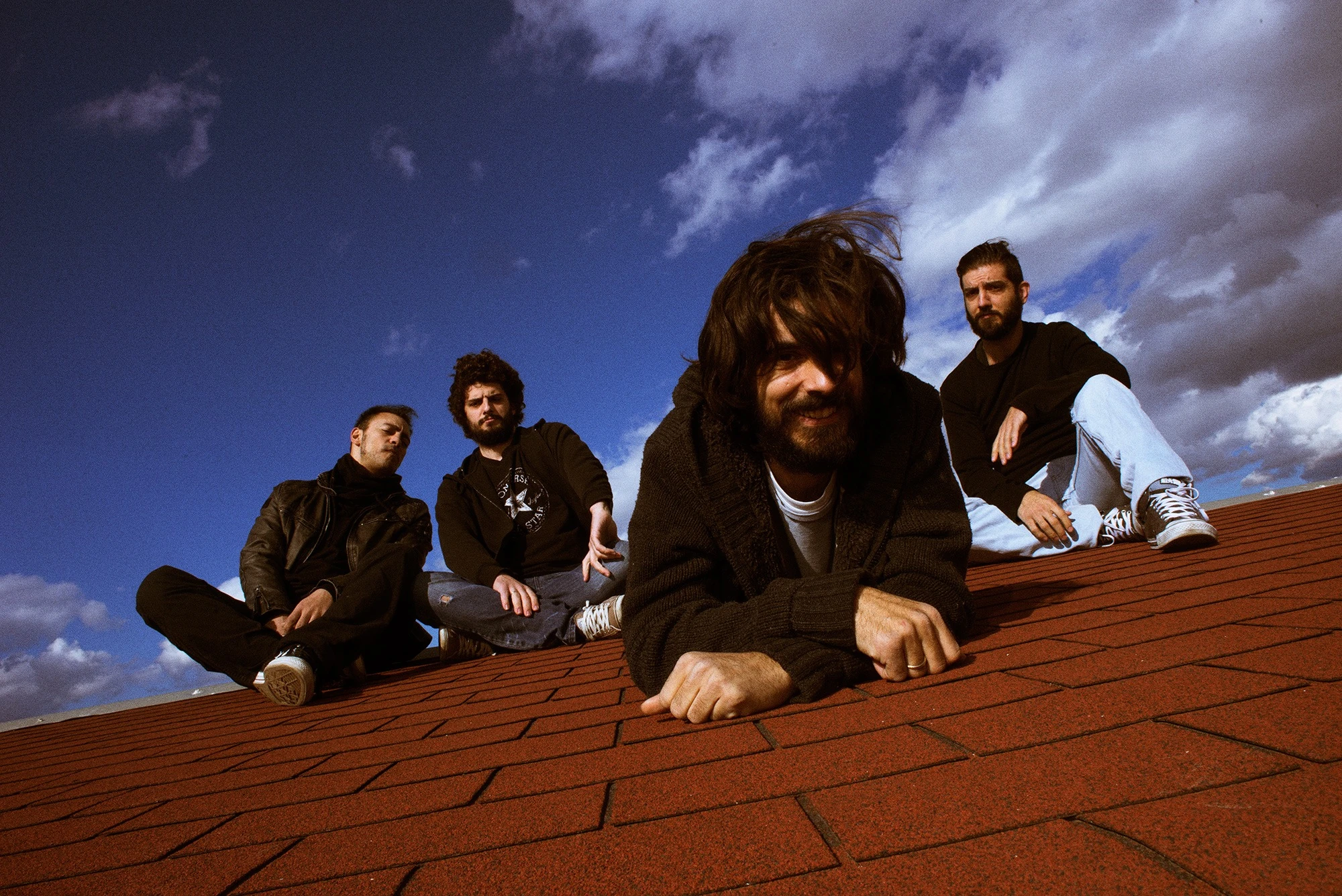 Sun, rain in life band members photographed on a rooftop during the 96/4 period.